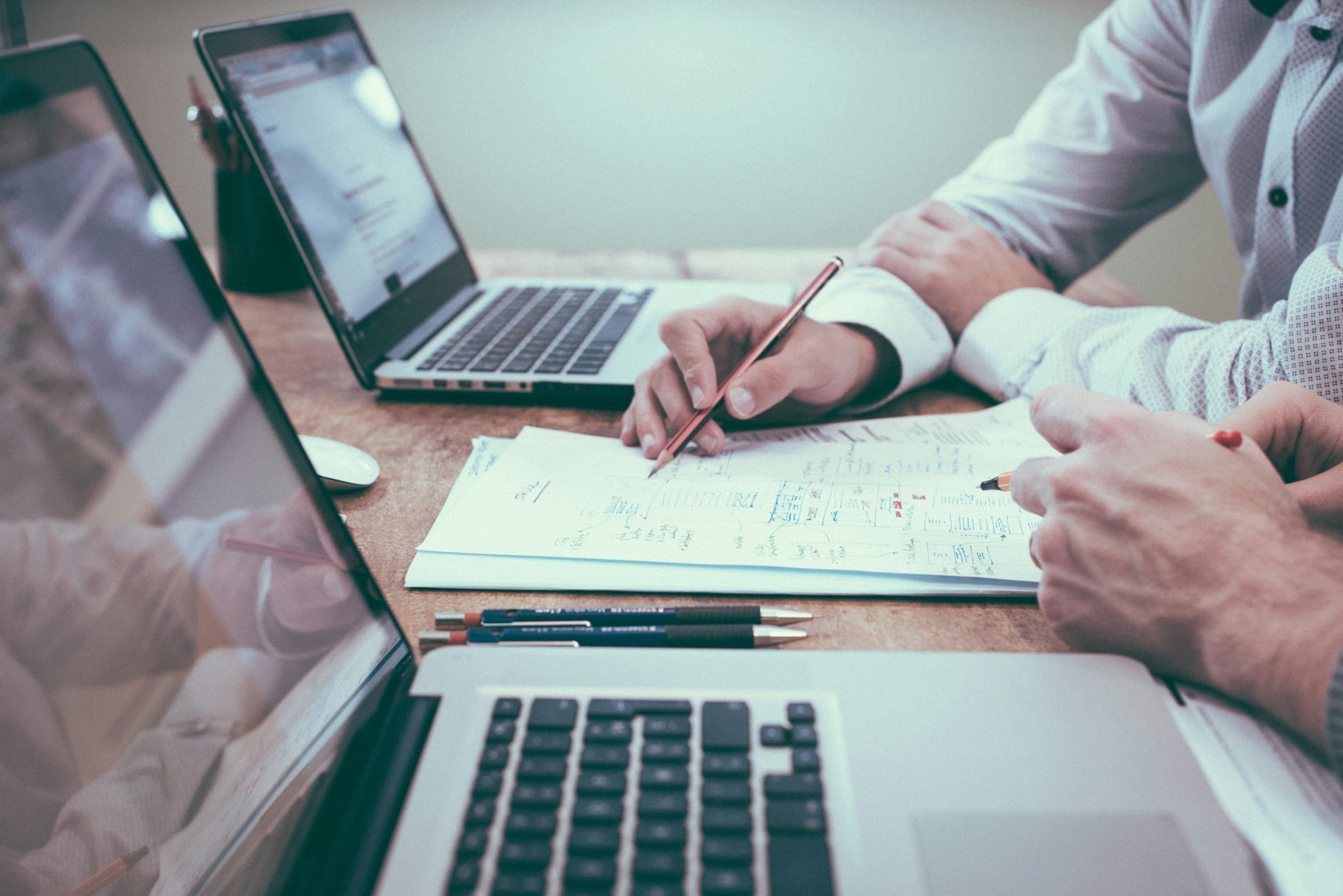 Two people reviewing property paperwork together at a desk