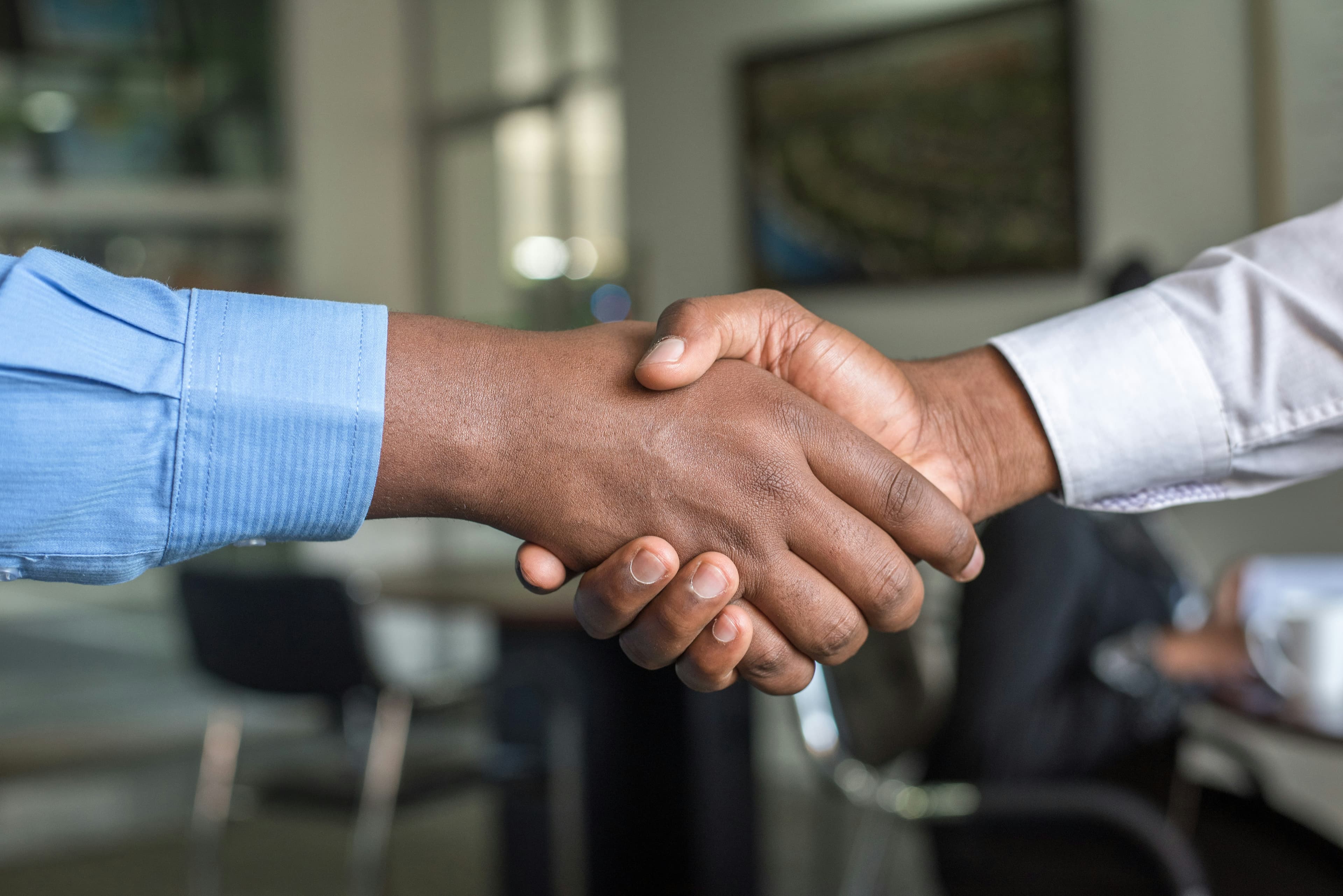 Two people shaking hands after agreeing terms