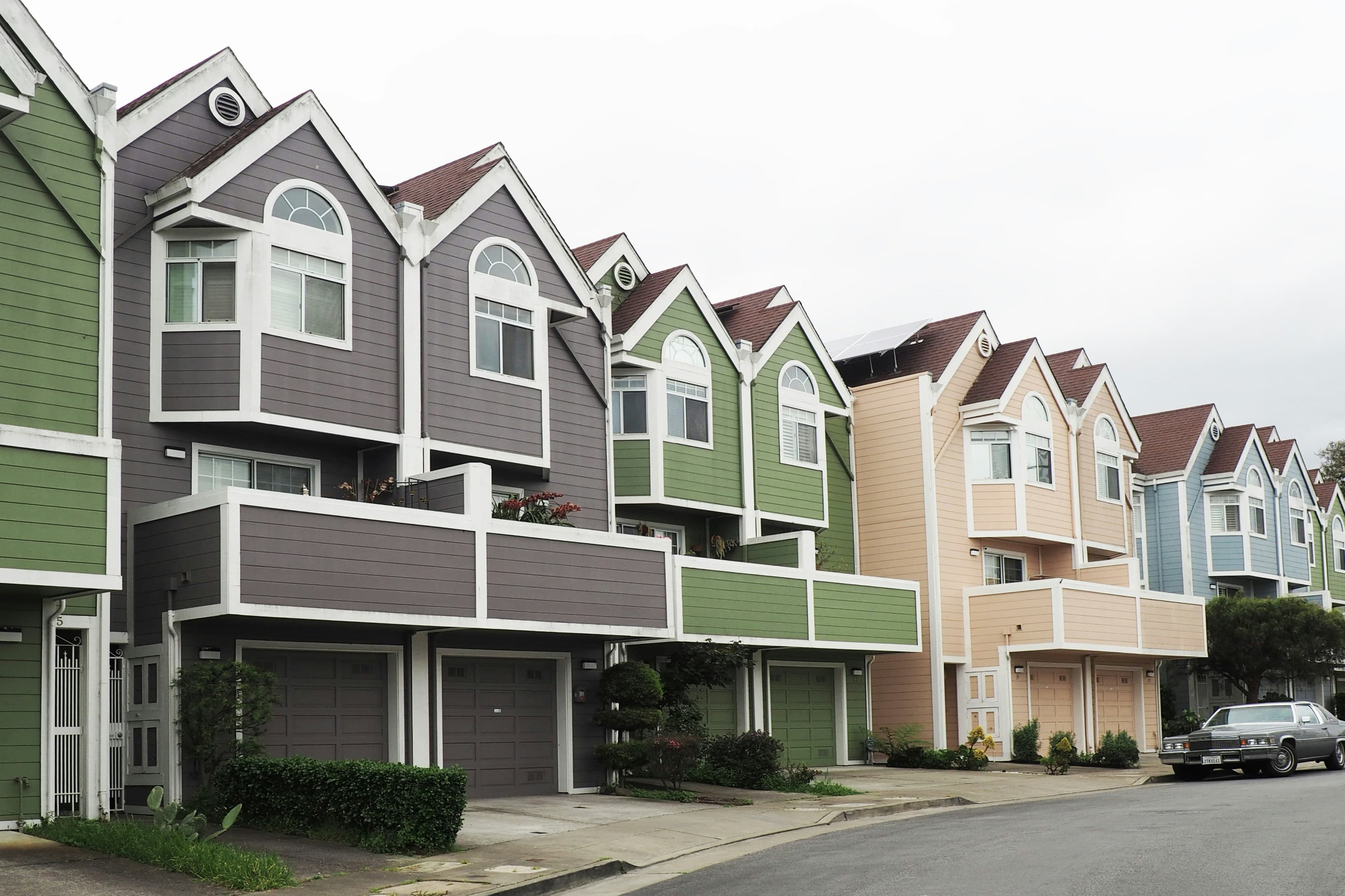 Row of modern terraced townhouses along a quiet street