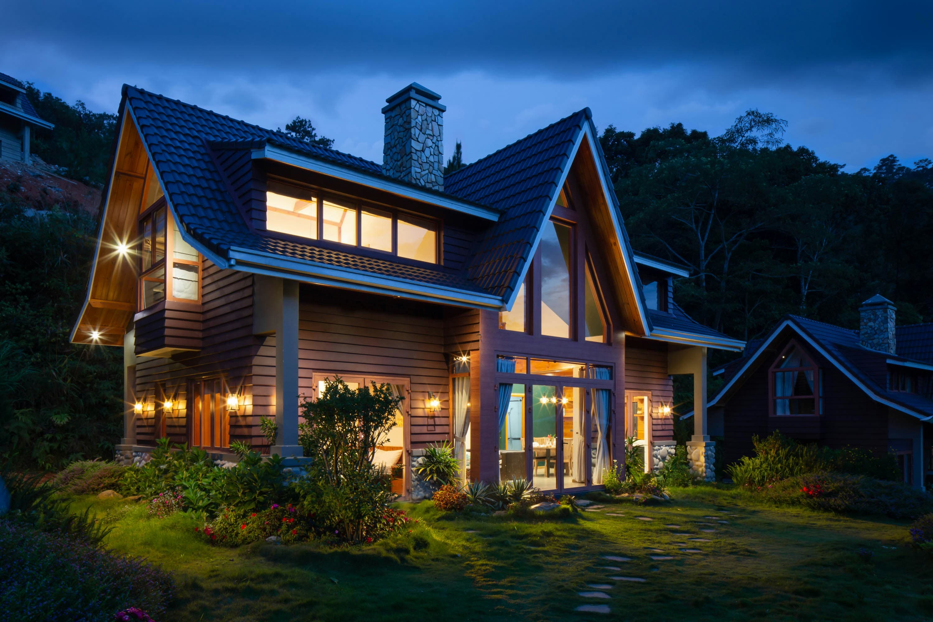 Detached family home at dusk with warm light in the windows