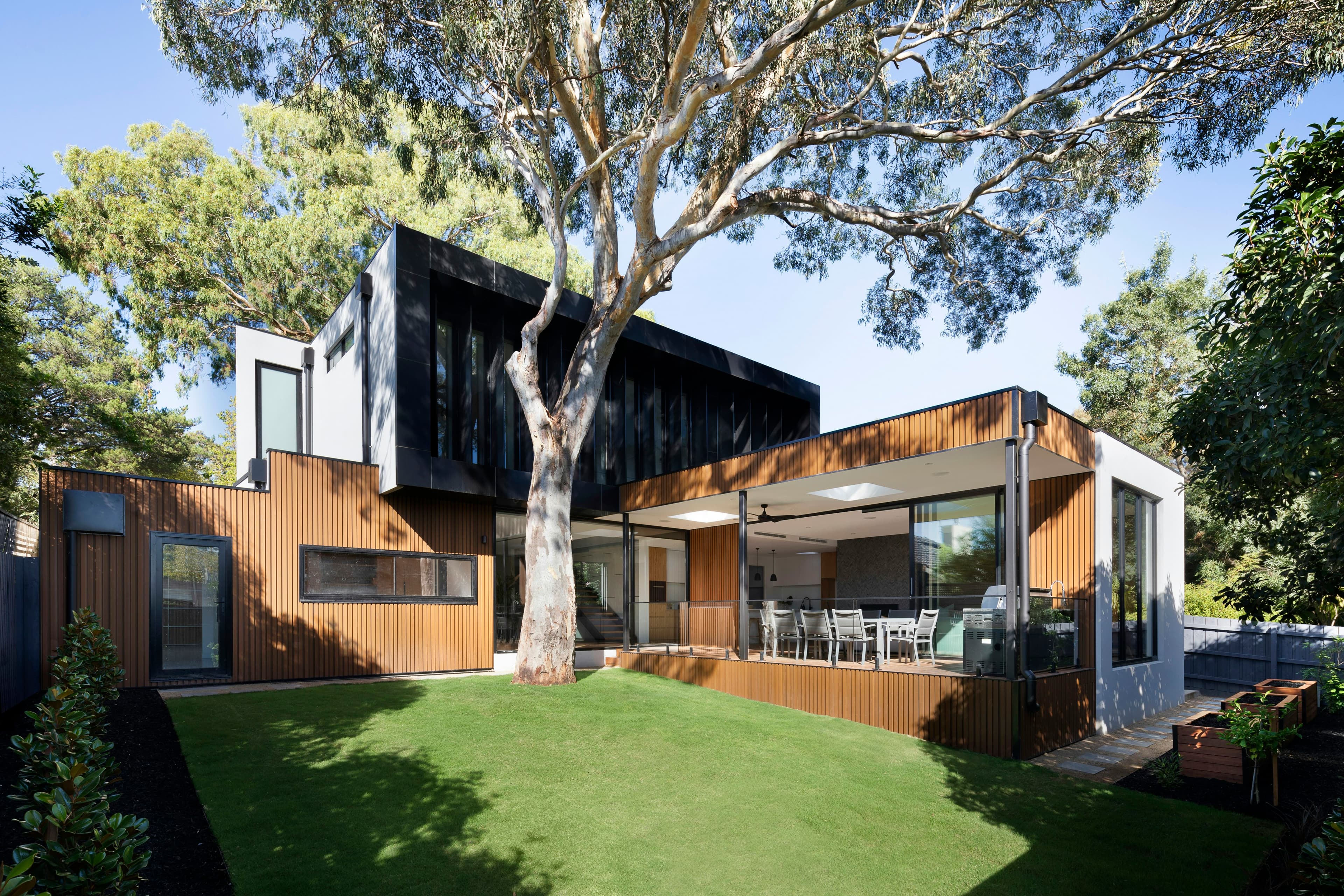 Modern timber-clad home with a well-kept garden lawn